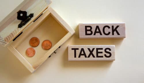 Back taxes written on wooden blocks
