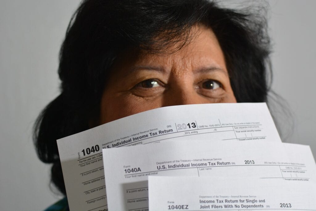 person holding up tax forms